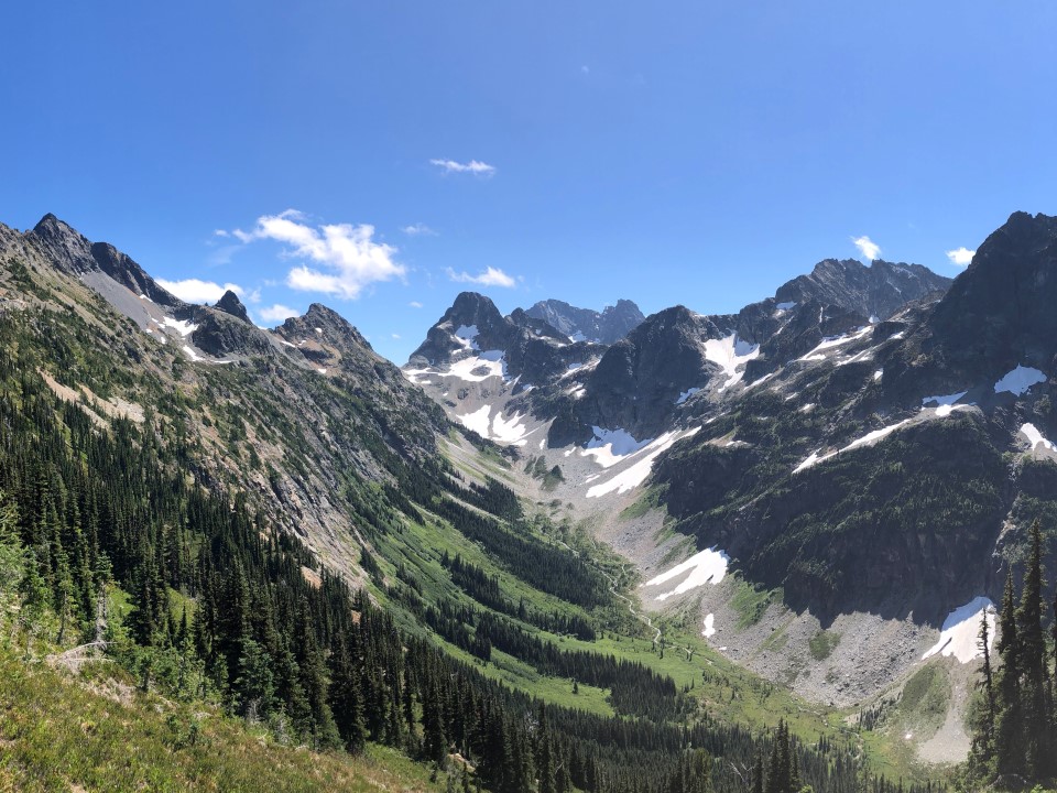 Panorama from the peak of Easy Pass trail showing glaciated mountains and valley meadows. North Cascades National Park, WA