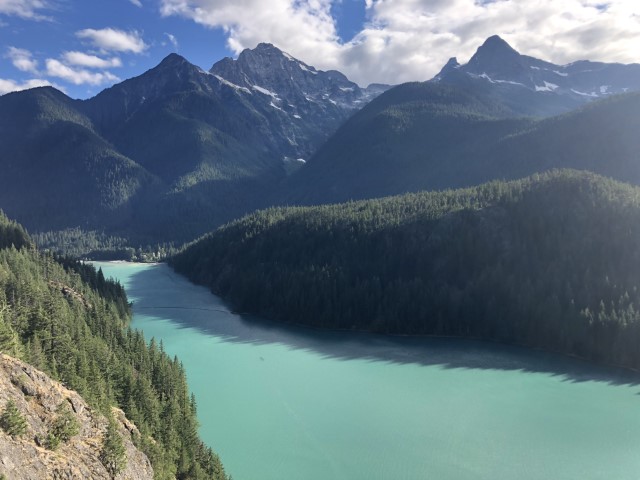 light-blue Lake Diablo in the foreground with snow-capped Colonial Peak in the background. Ross Lake National Recreation Area, WA